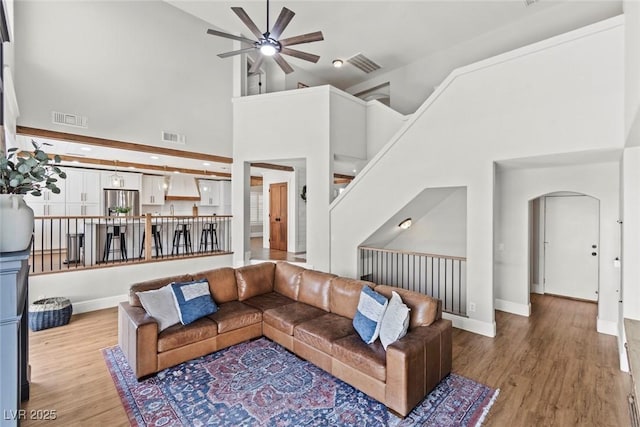 8820 Fall Green Ave, Las Vegas, NV 89129 - living area with a ceiling fan, high vaulted ceiling, wood finished floors, and arched walkways