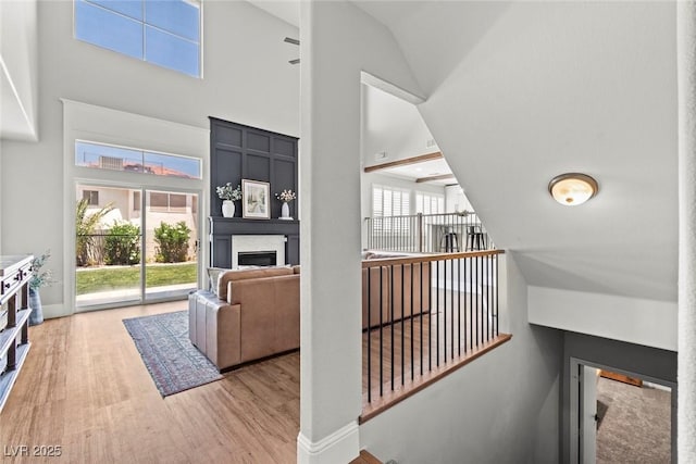 8820 Fall Green Ave, Las Vegas, NV 89129 - living room with high vaulted ceiling, light wood-style floors, and a fireplace