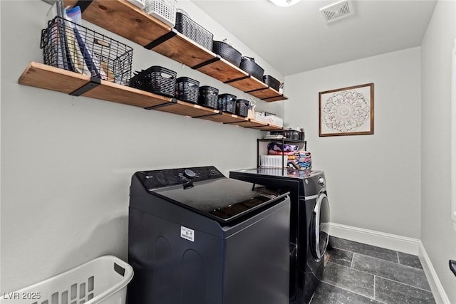 8820 Fall Green Ave, Las Vegas, NV 89129 - laundry room with separate washer and dryer and dark stone finish flooring