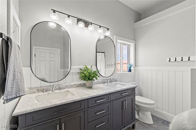 8820 Fall Green Ave, Las Vegas, NV 89129 - bathroom with double vanity and a wainscoted wall