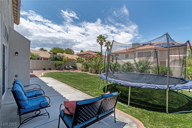 8820 Fall Green Ave, Las Vegas, NV 89129 - fenced backyard featuring a trampoline and a patio area