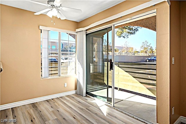 2101 Sealion Dr Unit 108, Las Vegas, NV 89128 - doorway featuring wood finished floors, plenty of natural light, and a ceiling fan