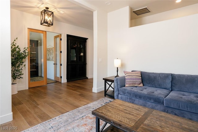 7745 Radcliff St, Las Vegas, NV 89123 - living area with wood finished floors and a chandelier
