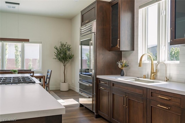 7745 Radcliff St, Las Vegas, NV 89123 - kitchen featuring stainless steel appliances, dark wood-style flooring, healthy amount of natural light, and light countertops