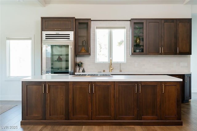 7745 Radcliff St, Las Vegas, NV 89123 - kitchen featuring beverage cooler, tasteful backsplash, plenty of natural light, and dark brown cabinets