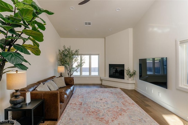 7745 Radcliff St, Las Vegas, NV 89123 - living room featuring wood finished floors, a glass covered fireplace, and recessed lighting
