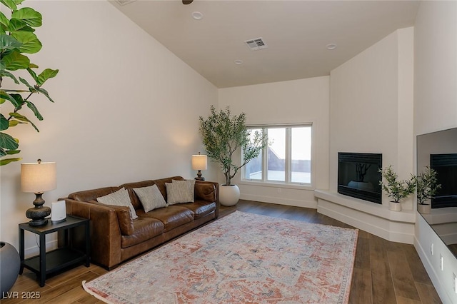 7745 Radcliff St, Las Vegas, NV 89123 - living area featuring wood finished floors and a glass covered fireplace