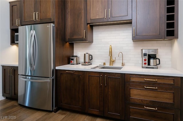 7745 Radcliff St, Las Vegas, NV 89123 - kitchen featuring freestanding refrigerator, decorative backsplash, light countertops, and dark brown cabinets