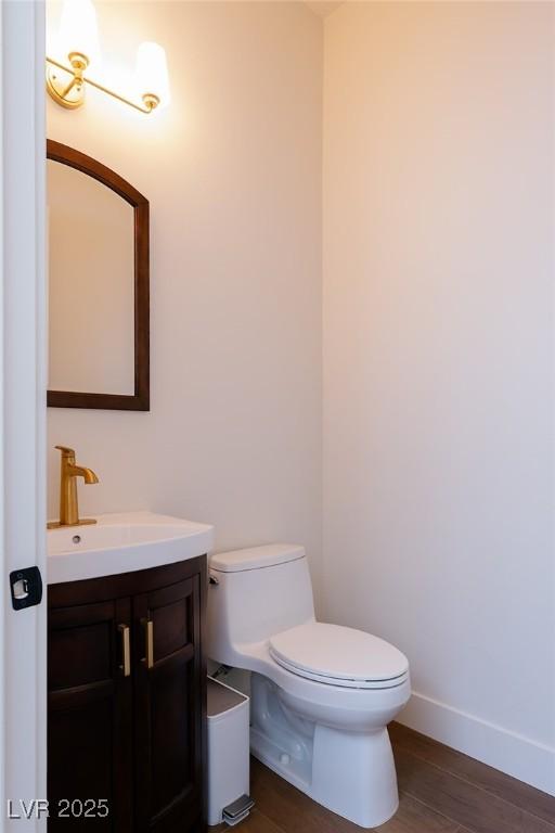 7745 Radcliff St, Las Vegas, NV 89123 - half bathroom with vanity and wood finished floors