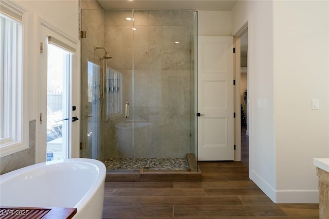 7745 Radcliff St, Las Vegas, NV 89123 - full bathroom with a soaking tub, a stall shower, wood finished floors, and vanity