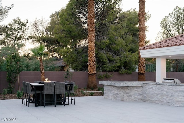 7745 Radcliff St, Las Vegas, NV 89123 - fenced backyard with an outdoor kitchen and a patio
