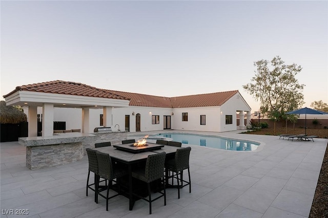 7745 Radcliff St, Las Vegas, NV 89123 - view of swimming pool with a fire pit and a patio area