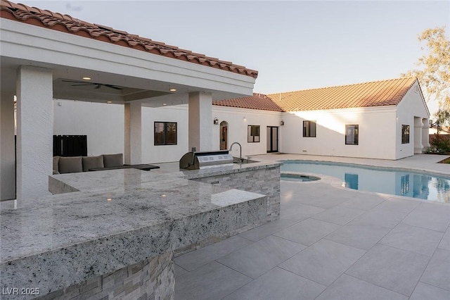 7745 Radcliff St, Las Vegas, NV 89123 - swimming pool with an outdoor kitchen, a patio area, and ceiling fan