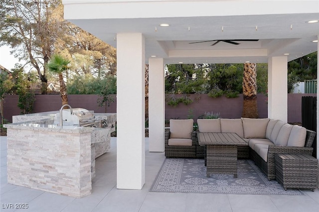 7745 Radcliff St, Las Vegas, NV 89123 - fenced backyard with an outdoor kitchen, a patio area, an outdoor living space, and a ceiling fan