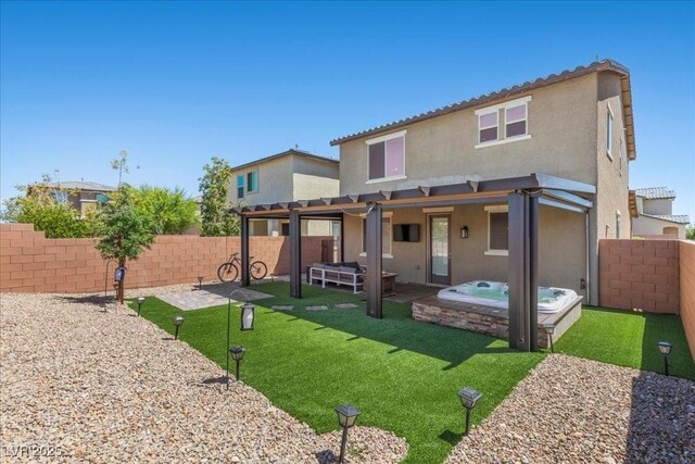 8013 Green River Knob St, Las Vegas, NV 89113 - rear view of property featuring an outdoor hot tub, stucco siding, a fenced backyard, and a patio