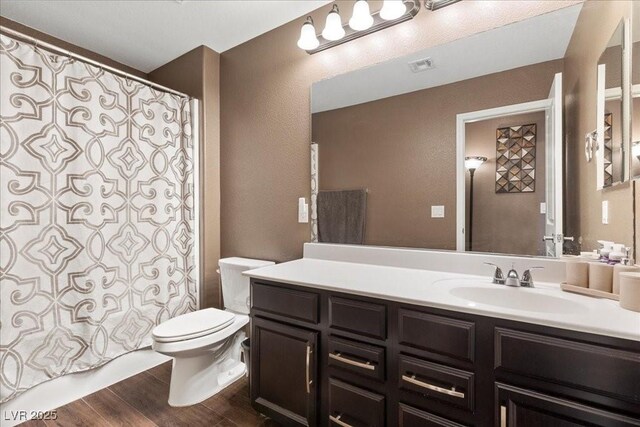 8013 Green River Knob St, Las Vegas, NV 89113 - bathroom with wood finished floors, vanity, a shower with shower curtain, and a textured wall