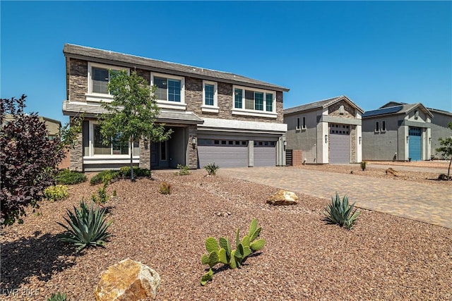 8753 Mann St, Las Vegas, NV 89139 - view of front of property with stone siding, driveway, and a garage