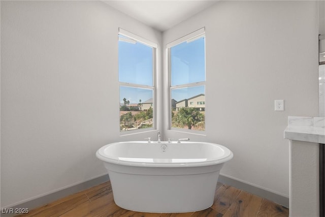 8753 Mann St, Las Vegas, NV 89139 - full bath featuring a freestanding bath and wood finished floors
