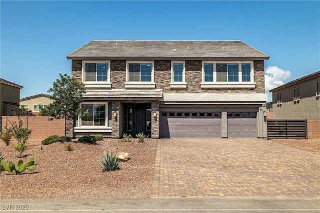 8753 Mann St, Las Vegas, NV 89139 - view of front of home featuring stone siding, decorative driveway, and an attached garage