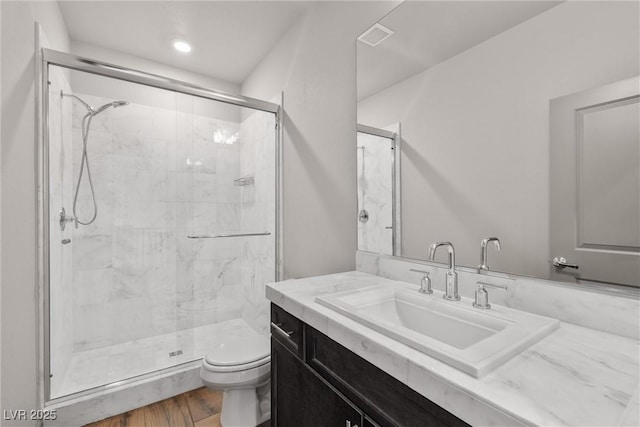 8753 Mann St, Las Vegas, NV 89139 - bathroom with a stall shower, vanity, and wood finished floors