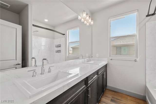 8753 Mann St, Las Vegas, NV 89139 - full bathroom featuring double vanity and wood finished floors
