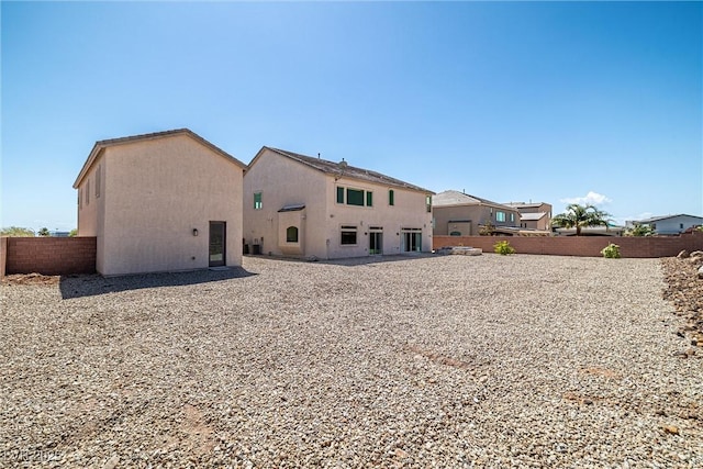 8753 Mann St, Las Vegas, NV 89139 - back of property featuring a fenced backyard and stucco siding
