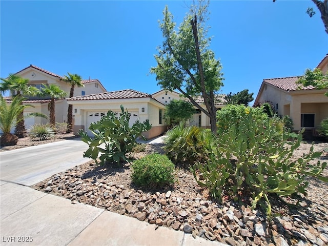 13 Desert Dawn Ln, Henderson, NV 89074 - mediterranean / spanish house featuring stucco siding, an attached garage, a tiled roof, and driveway