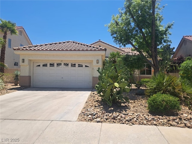 13 Desert Dawn Ln, Henderson, NV 89074 - mediterranean / spanish house featuring a tile roof, concrete driveway, and stucco siding