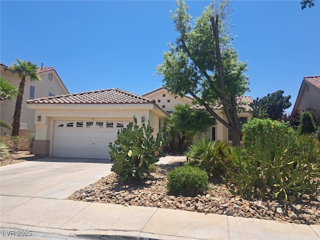 13 Desert Dawn Ln, Henderson, NV 89074 - mediterranean / spanish home featuring a tiled roof, an attached garage, driveway, and stucco siding