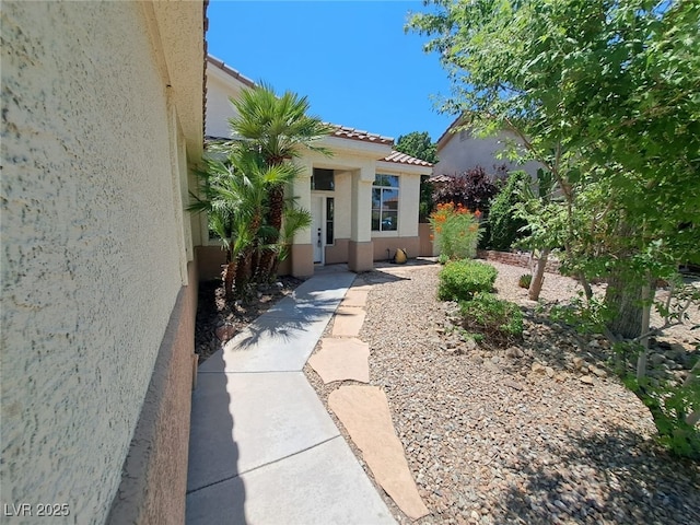 13 Desert Dawn Ln, Henderson, NV 89074 - view of exterior entry with stucco siding and a tile roof