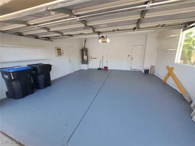 13 Desert Dawn Ln, Henderson, NV 89074 - garage featuring strapped water heater, a garage door opener, and a wall mounted air conditioner