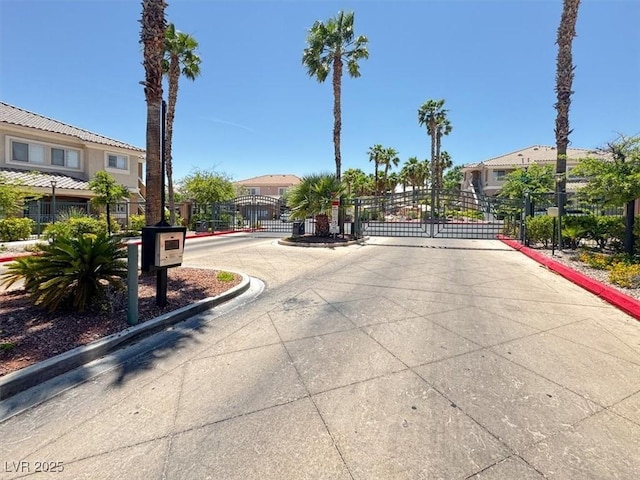 10553 Pine Glen Ave Unit 101, Las Vegas, NV 89144 - view of concrete street featuring a gate, curbs, a gated entry, and a residential view