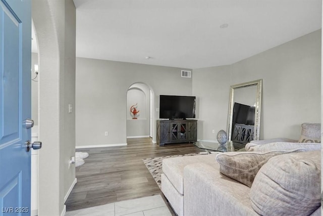 10553 Pine Glen Ave Unit 101, Las Vegas, NV 89144 - living room featuring arched walkways and wood finished floors