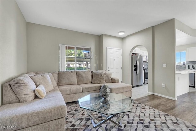 10553 Pine Glen Ave Unit 101, Las Vegas, NV 89144 - living room with arched walkways and light wood-type flooring