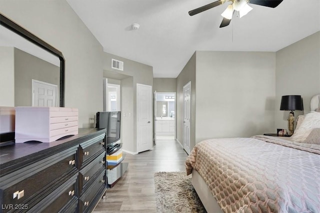 10553 Pine Glen Ave Unit 101, Las Vegas, NV 89144 - bedroom featuring light wood-style floors, connected bathroom, and a ceiling fan