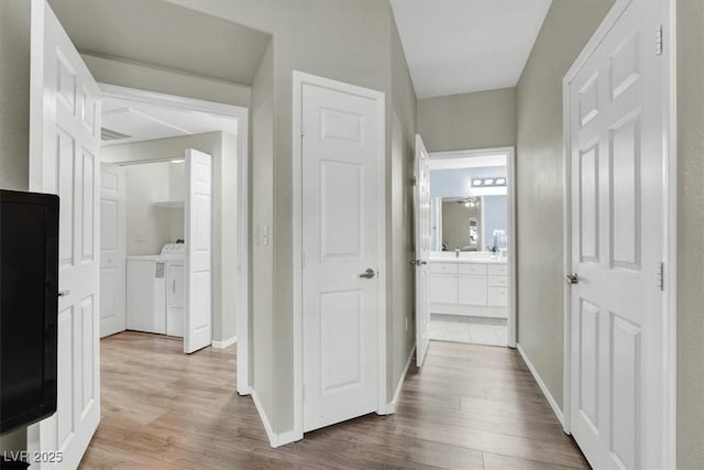 10553 Pine Glen Ave Unit 101, Las Vegas, NV 89144 - hall with washer and clothes dryer and wood finished floors