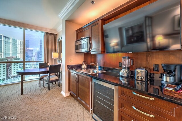 135 E Harmon Ave Unit 809, Las Vegas, NV 89109 - kitchen with beverage cooler, ornamental molding, stainless steel microwave, dark stone counters, and brown cabinetry