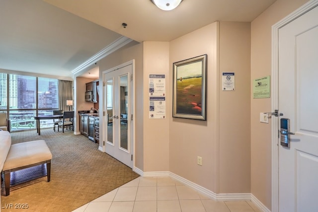 135 E Harmon Ave Unit 809, Las Vegas, NV 89109 - corridor with french doors, light tile patterned floors, crown molding, floor to ceiling windows, and light carpet