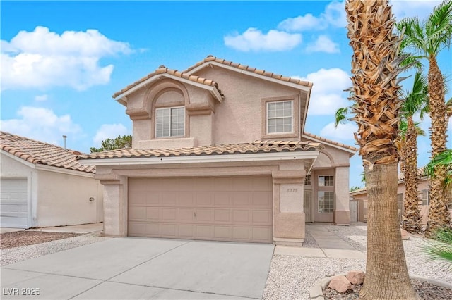 8379 Drop Camp St, Las Vegas, NV 89123 - mediterranean / spanish-style home featuring a tile roof, stucco siding, concrete driveway, and a garage
