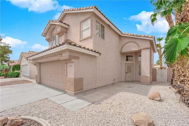 8379 Drop Camp St, Las Vegas, NV 89123 - mediterranean / spanish home with a tiled roof, stucco siding, an attached garage, and driveway