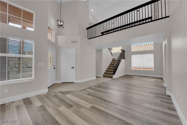 8379 Drop Camp St, Las Vegas, NV 89123 - entryway featuring stairs, wood finished floors, high vaulted ceiling, and a chandelier