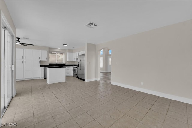 8379 Drop Camp St, Las Vegas, NV 89123 - kitchen with stainless steel appliances, open floor plan, white cabinets, dark countertops, and ceiling fan