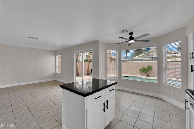 8379 Drop Camp St, Las Vegas, NV 89123 - kitchen featuring light tile patterned floors, plenty of natural light, a ceiling fan, and dark countertops