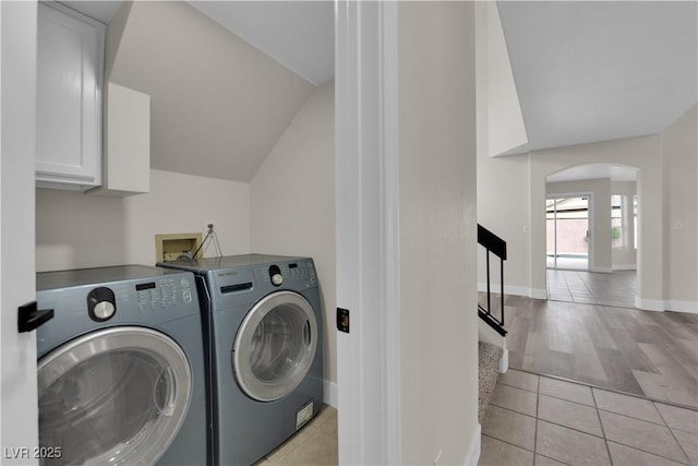 8379 Drop Camp St, Las Vegas, NV 89123 - laundry area with washer and clothes dryer, light tile patterned floors, arched walkways, and cabinet space