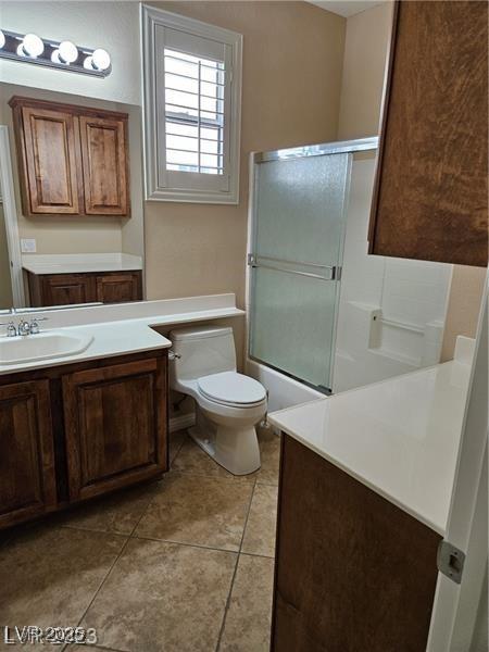 5110 Silenzio St, Las Vegas, NV 89135 - full bath with vanity, tile patterned flooring, and combined bath / shower with glass door