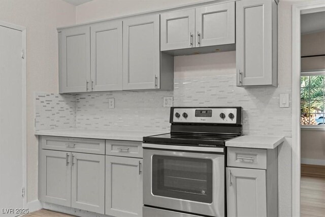 1628 Izabella Ave, Las Vegas, NV 89169 - kitchen featuring stainless steel electric range, gray cabinetry, light countertops, and tasteful backsplash