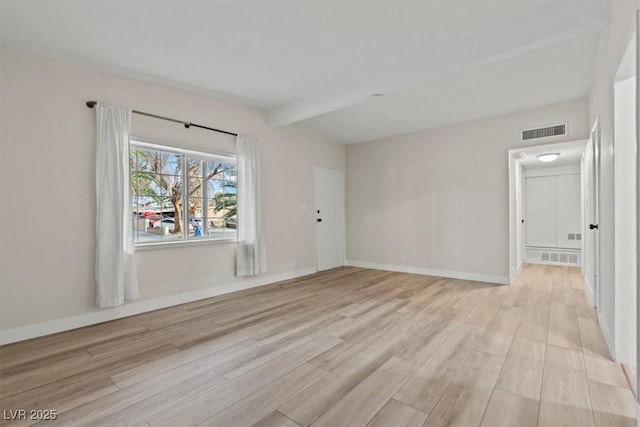 1628 Izabella Ave, Las Vegas, NV 89169 - spare room with light wood-style floors and beamed ceiling