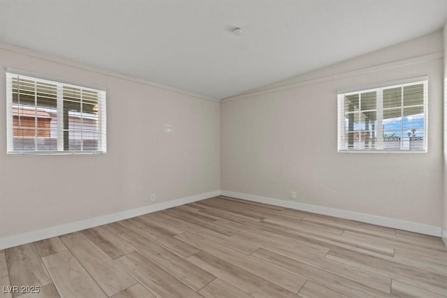 1628 Izabella Ave, Las Vegas, NV 89169 - spare room with healthy amount of natural light, vaulted ceiling, light wood-type flooring, and ornamental molding