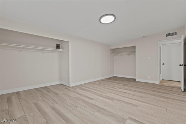 1628 Izabella Ave, Las Vegas, NV 89169 - unfurnished bedroom featuring light wood-type flooring and multiple closets