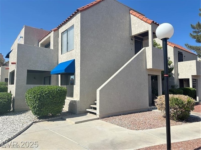 4230 Gannet Cir Unit 216, Las Vegas, NV 89103 - view of side of property with a tile roof and stucco siding